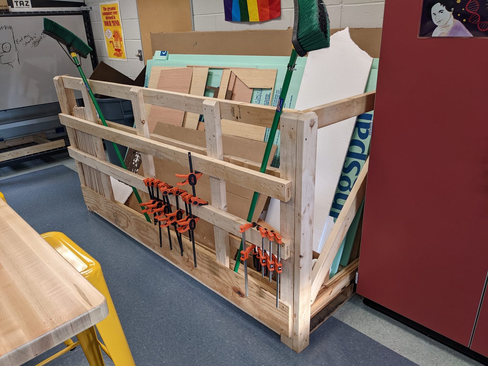 After: the finished plywood storage rack loaded with sheet materials and clamps