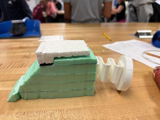 Green foam CO2 car body with a 3D-printed wheel piece attached