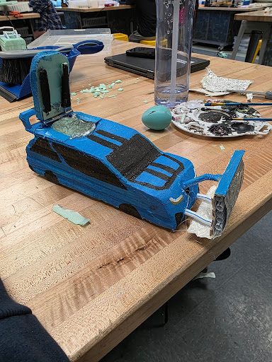 Finished CO2 car foam body painted as a blue sedan with black windows