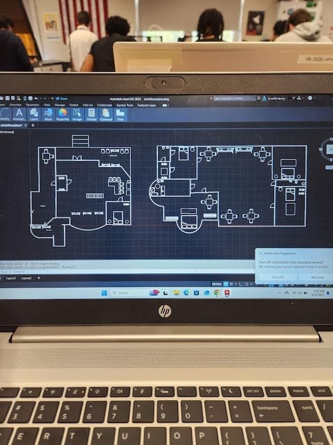 Laptop screen showing an AutoCAD floor plan drawing in progress