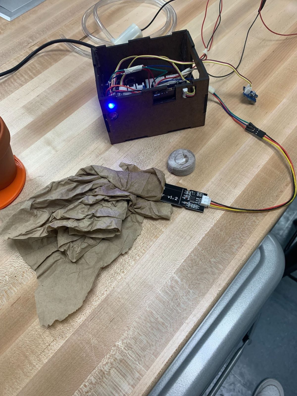 Open laser-cut control box showing the Arduino, wiring, and OLED display inside