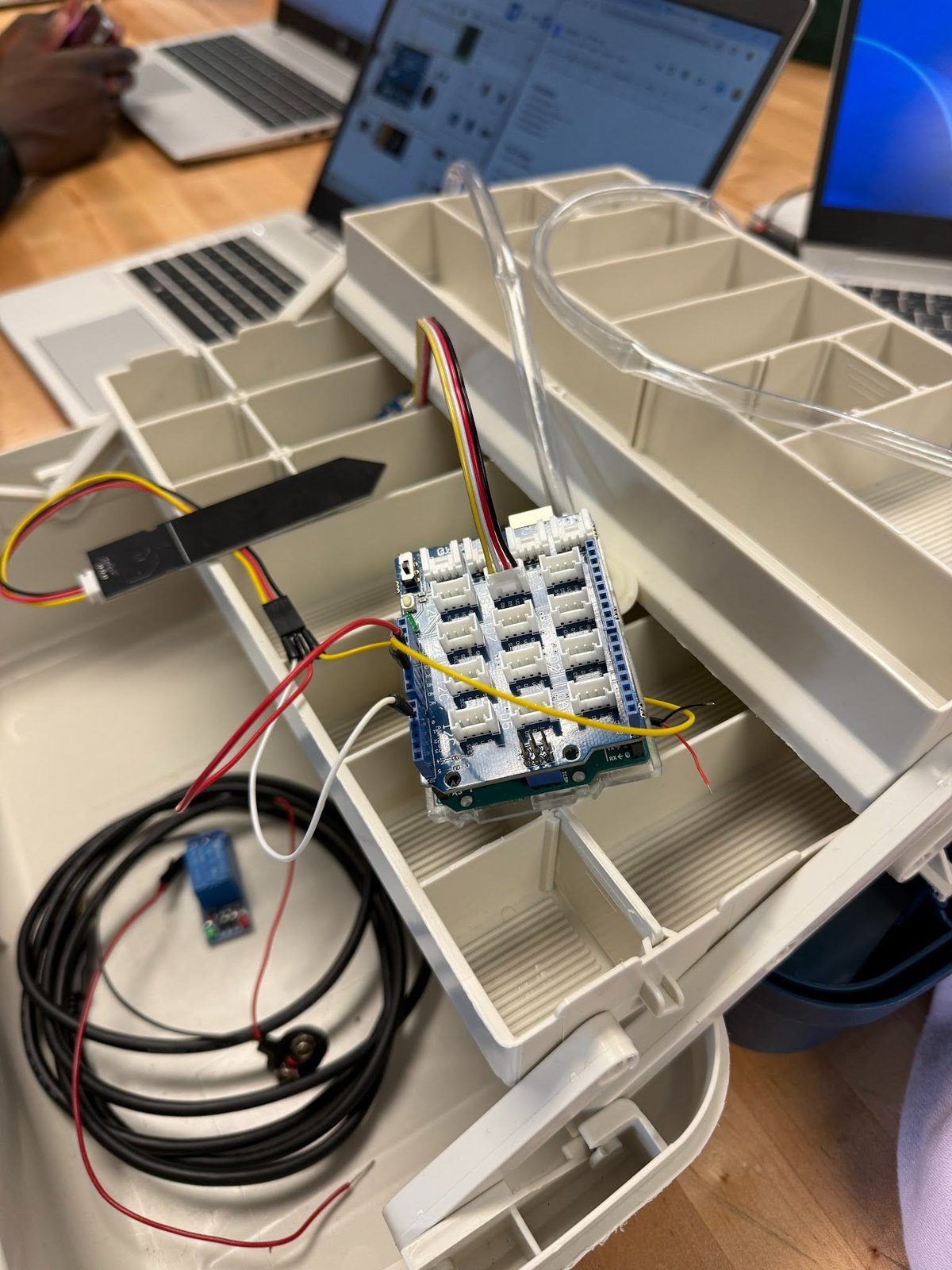 Water pump and relay wiring for the irrigation system laid out in a parts tray