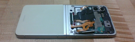 A disassembled phone hinge showing the internal circuit boards and ribbon cables