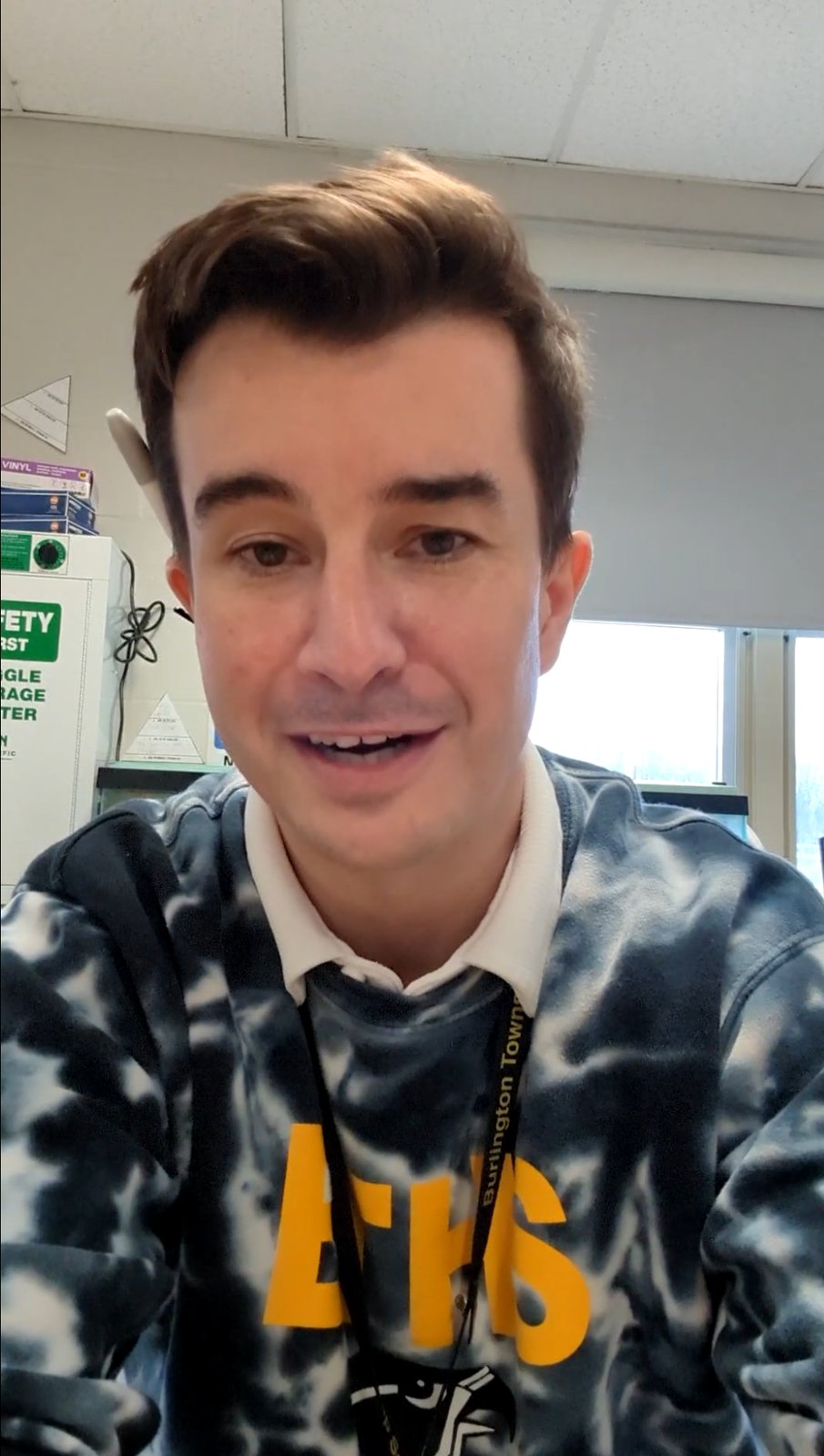 Dalton Fowler wearing a Burlington Township High School sweatshirt in his classroom