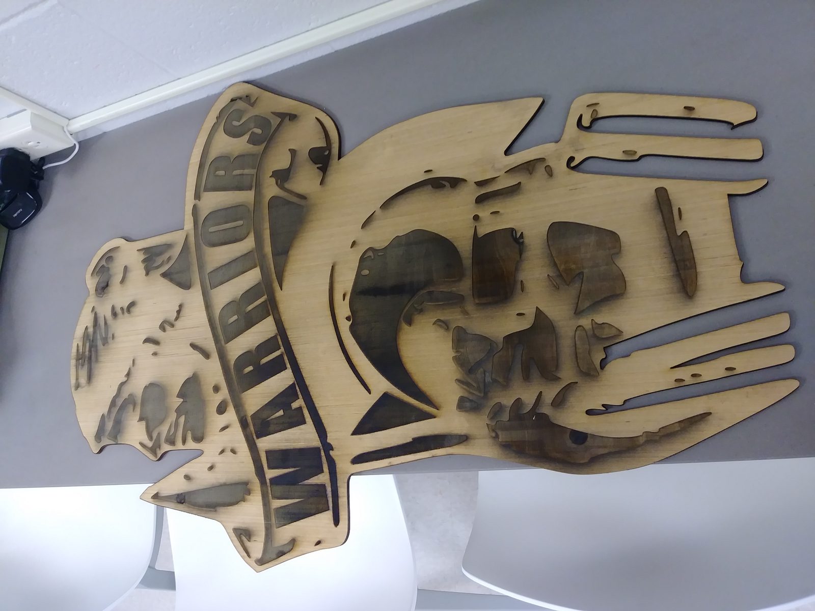 Laser-cut wooden NE Warriors mascot logo
