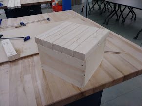 Single unstained wood-plank box early in the build