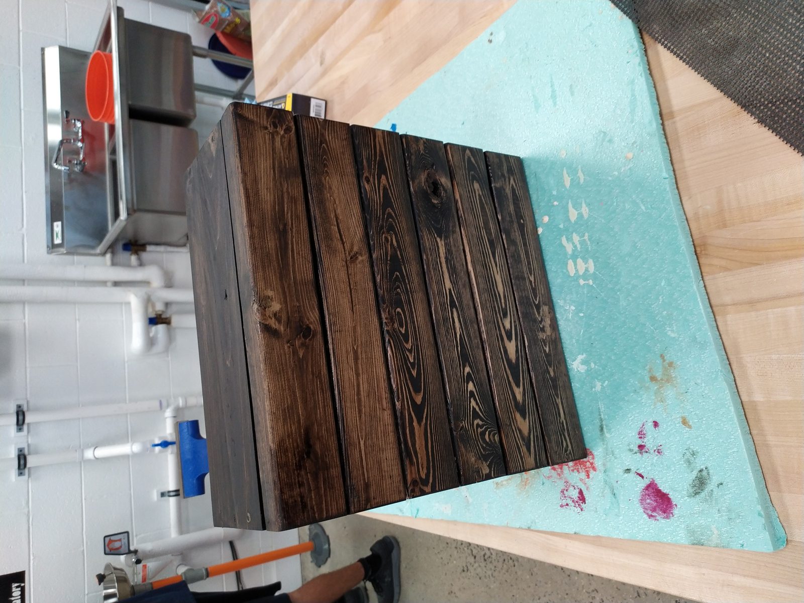 Close-up of a finished dark-stained wood-plank centerpiece box