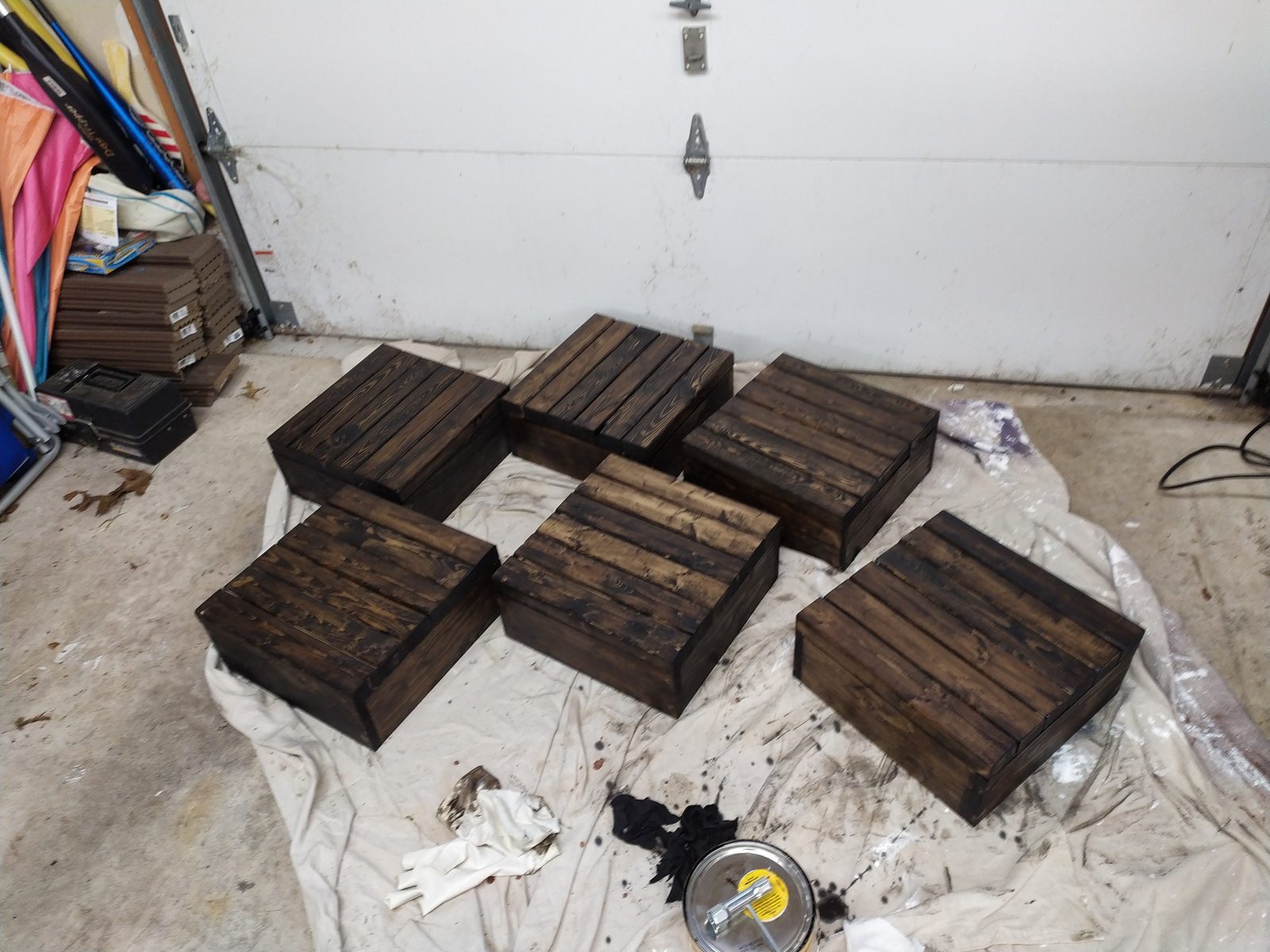 Six finished wood-plank centerpiece boxes, stained and drying