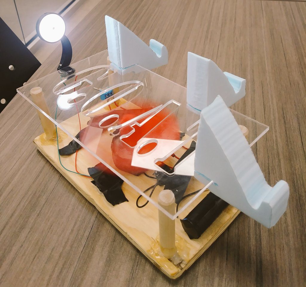 A laser-cut acrylic and foam phone stand design with an LED light built in