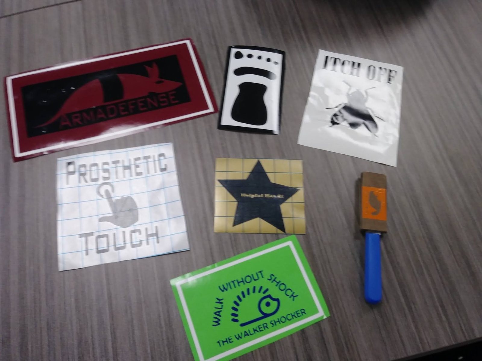 Biomimicry-inspired assistive tech branding stickers, including an armadillo-shielded case design, a bee-themed anti-itch product, and a prosthetic touch logo