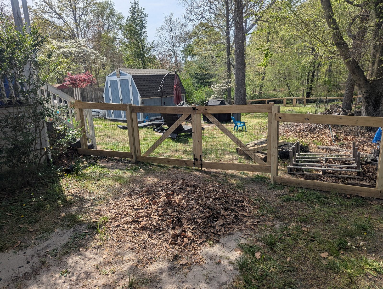 Freshly cleared fence line with a brush pile