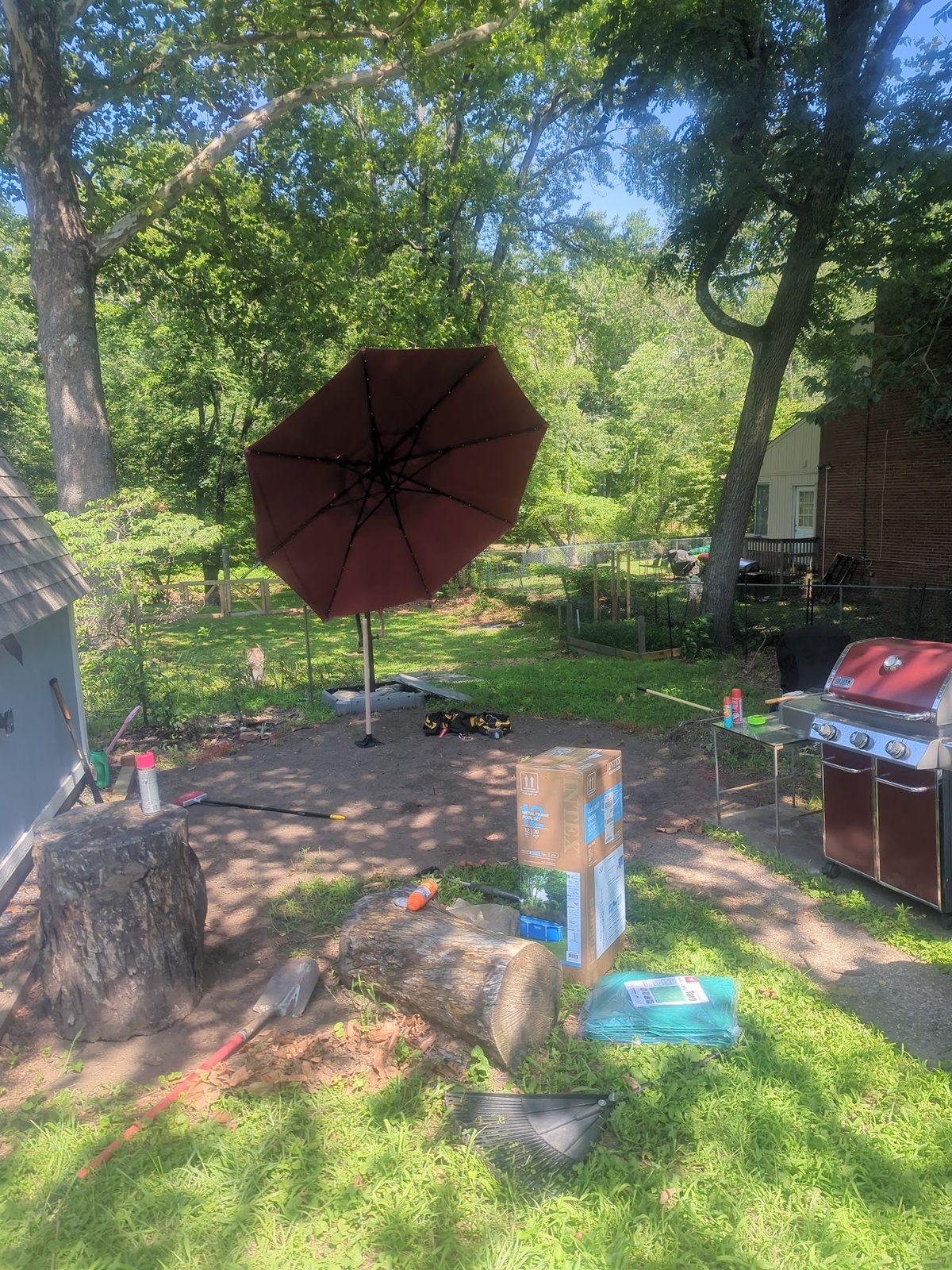 Patio umbrella and grill on the back patio