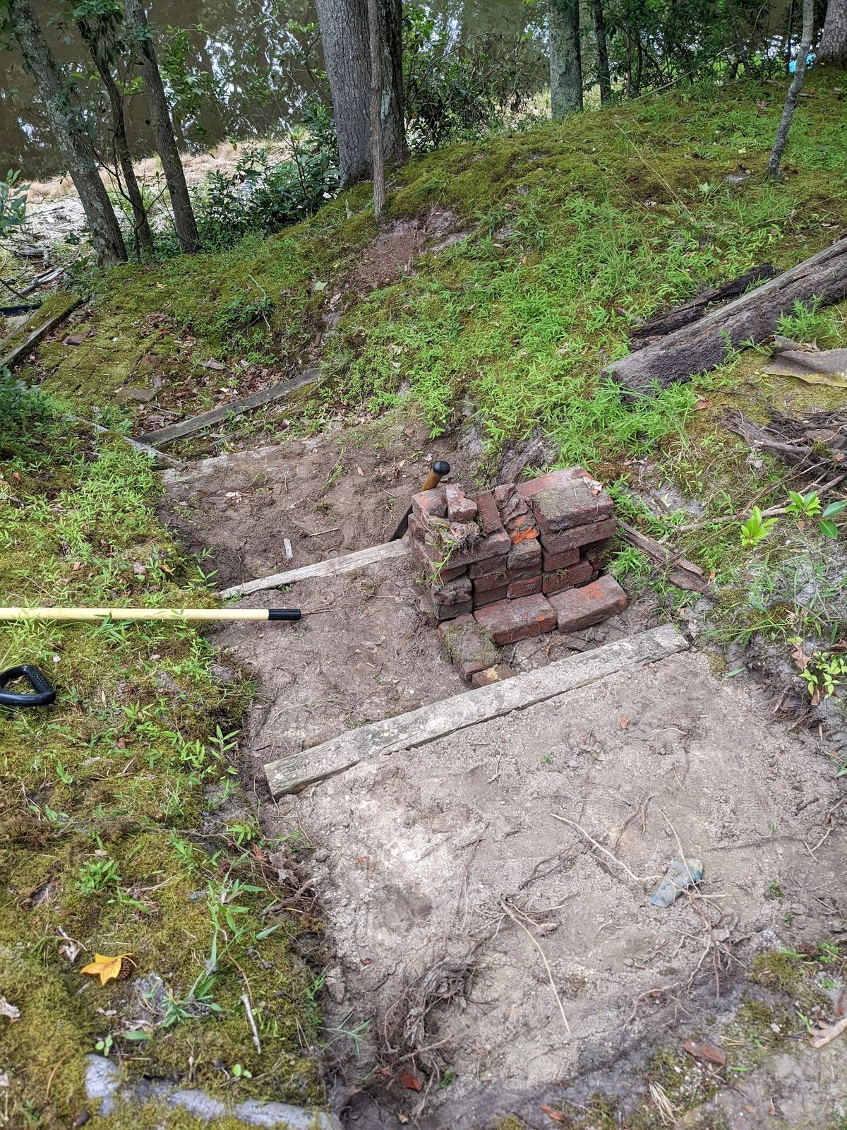Digging out the old steps and staging the slope for rebuilding
