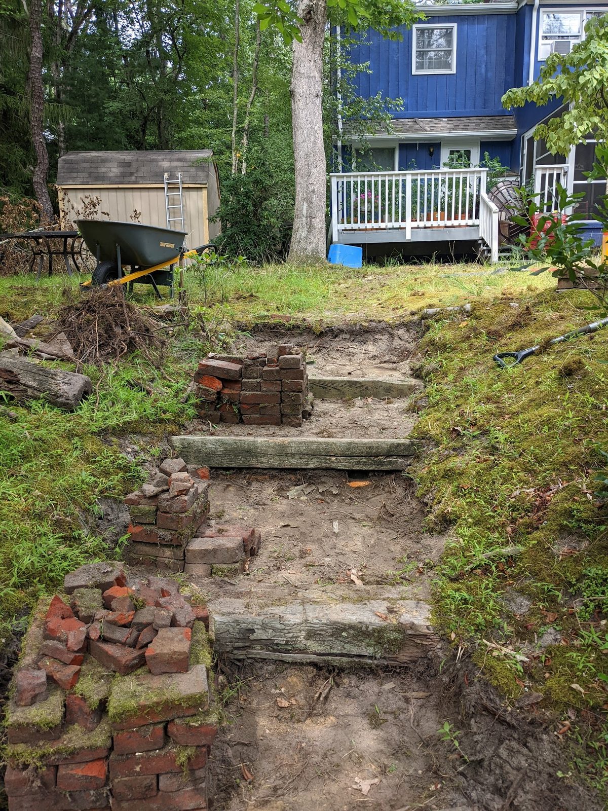New wood-framed step borders being set into the slope