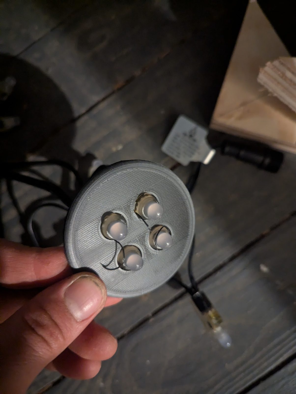 3D-printed light housing with four LEDs wired in, held in hand