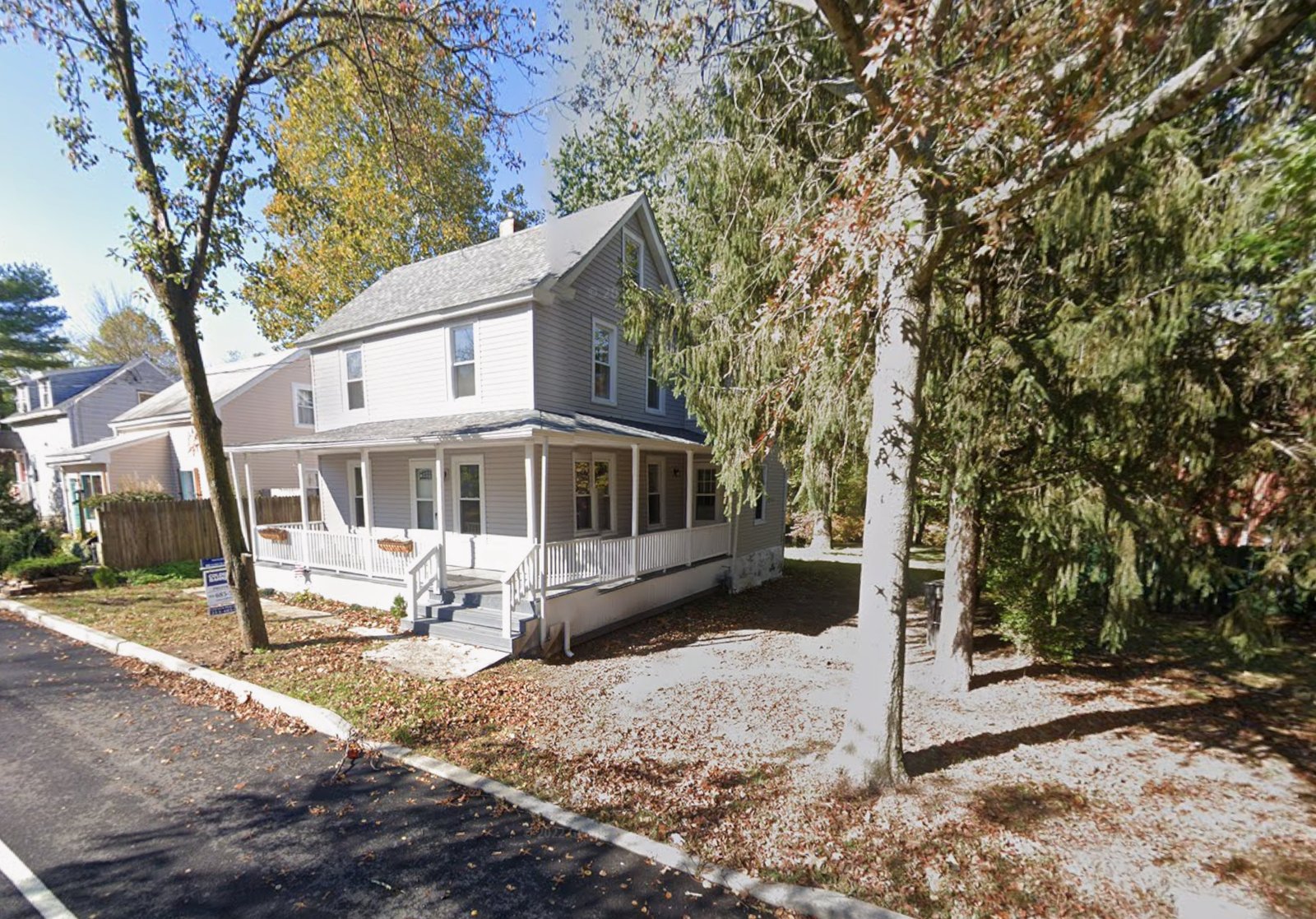 Real estate listing photo from when we bought the house, porch already opened up by a previous flip, bare mulch beds
