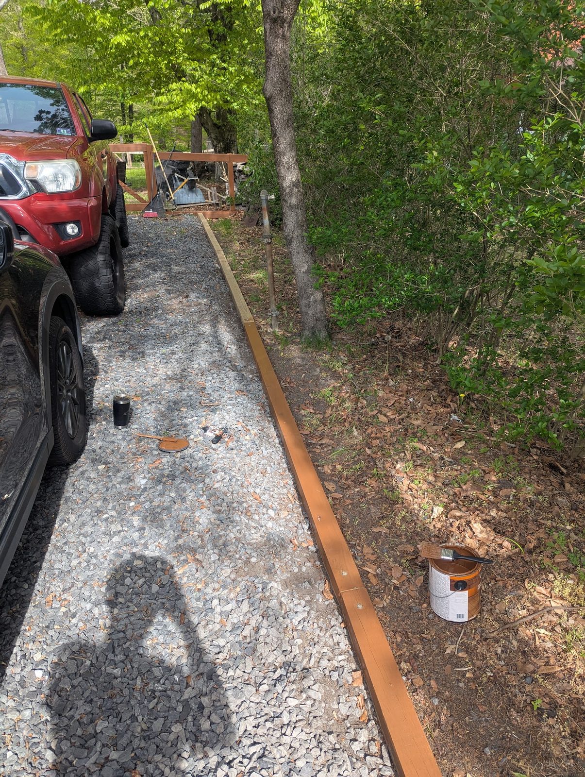Truck parked on the gravel driveway among the trees