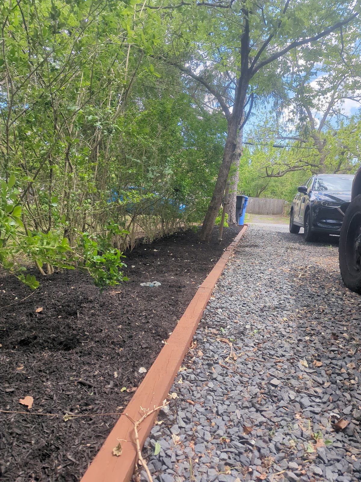Newly mulched planting bed with a rusty steel edging border