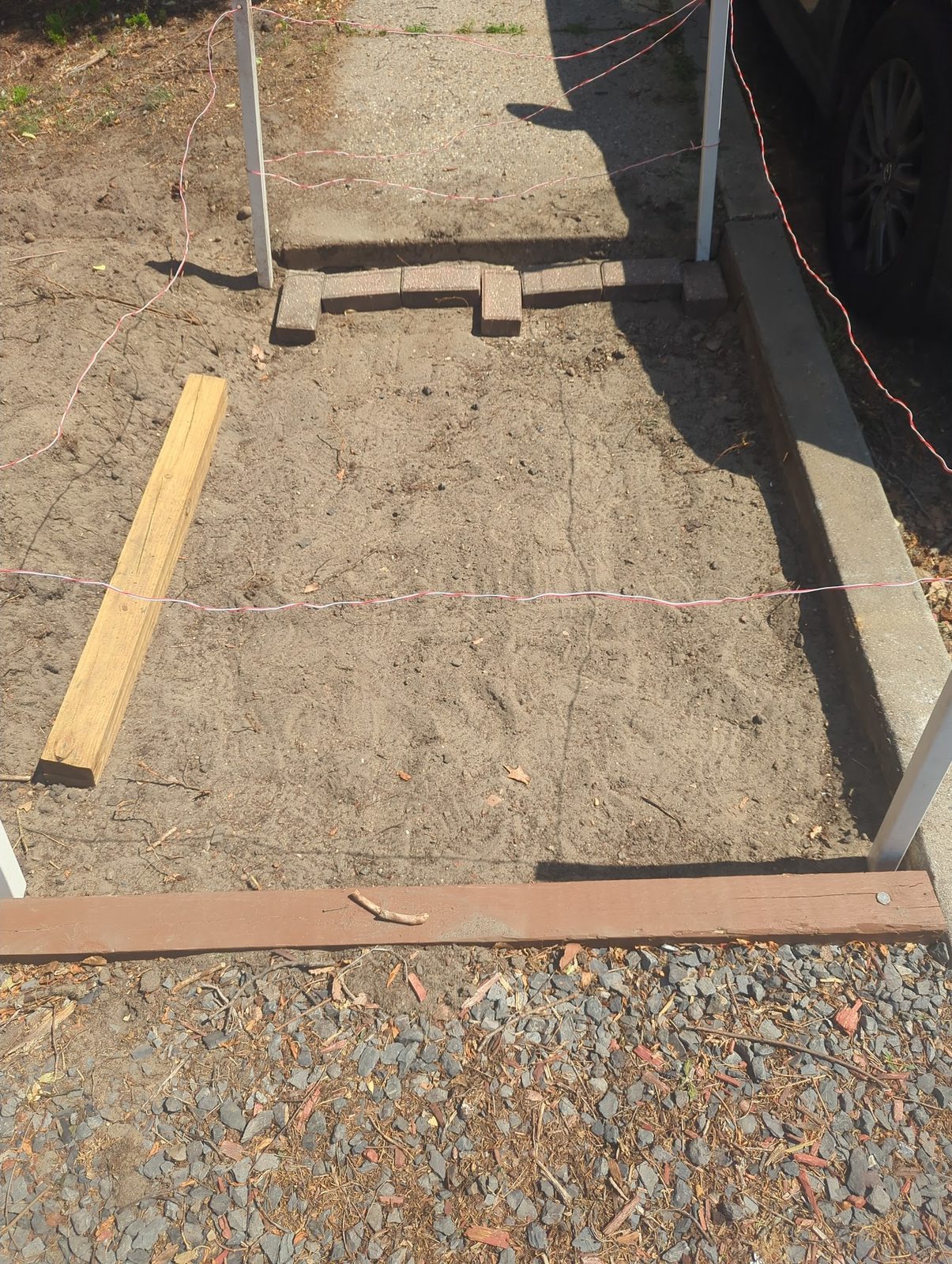 Lumber form staked out for the front walkway, ready for base material