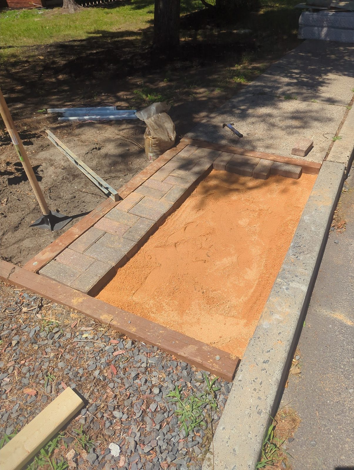 Sand base being leveled for the brick walkway