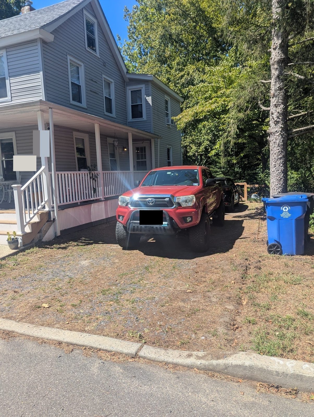 House with truck parked on the bare dirt driveway before gravel was laid