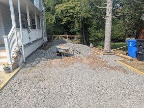 Pile of gravel dumped at the start of the new driveway