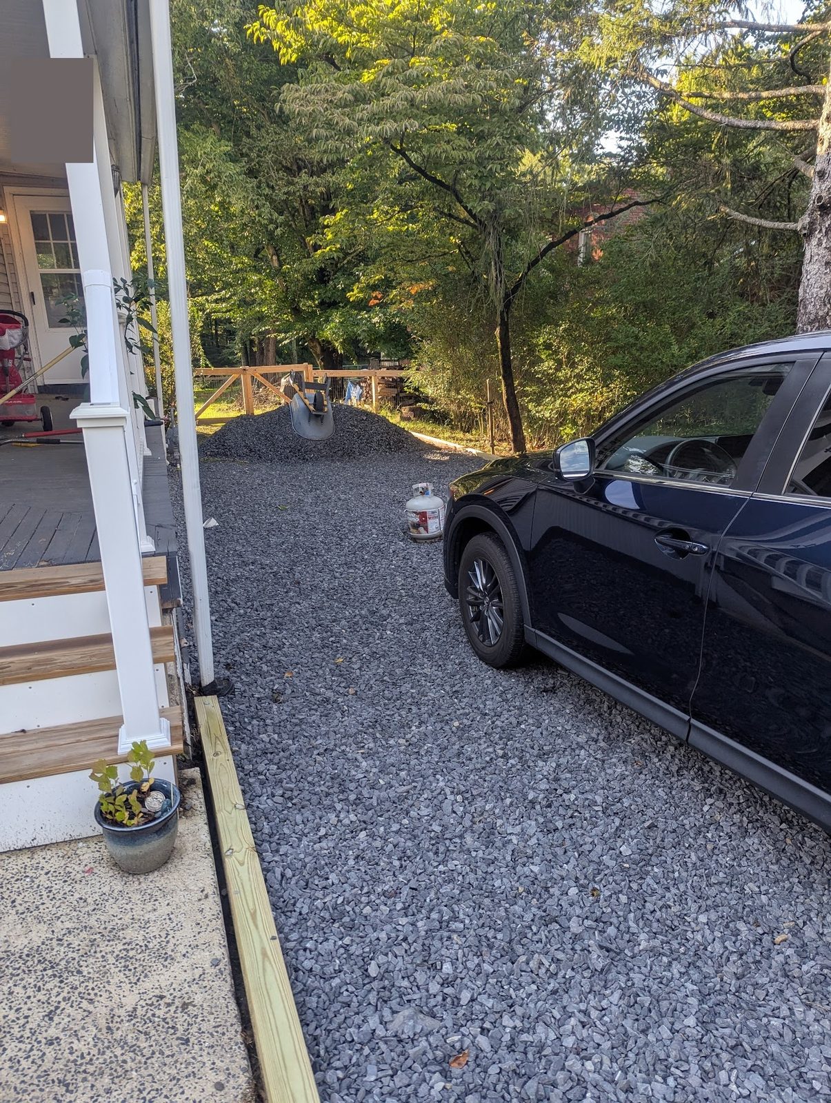 Car parked on the new gravel driveway looking toward the road