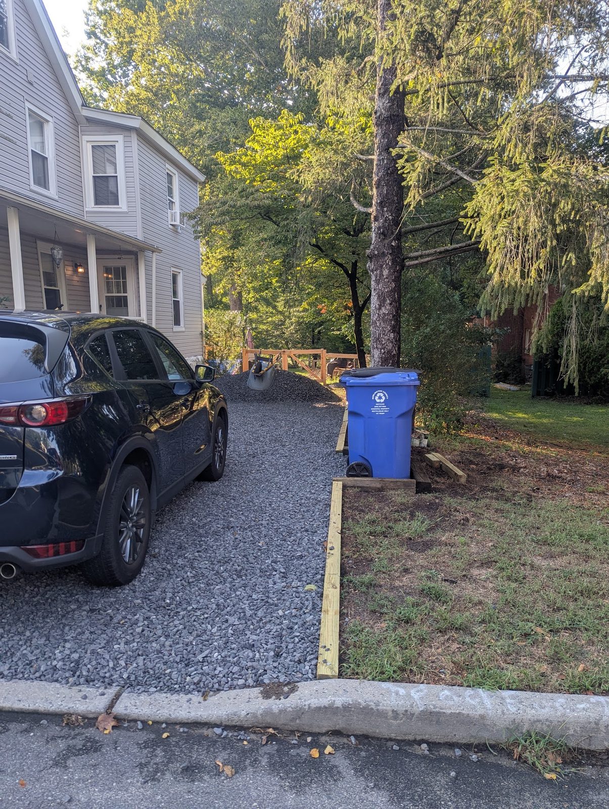 Car parked on the new gravel driveway, view back toward the house