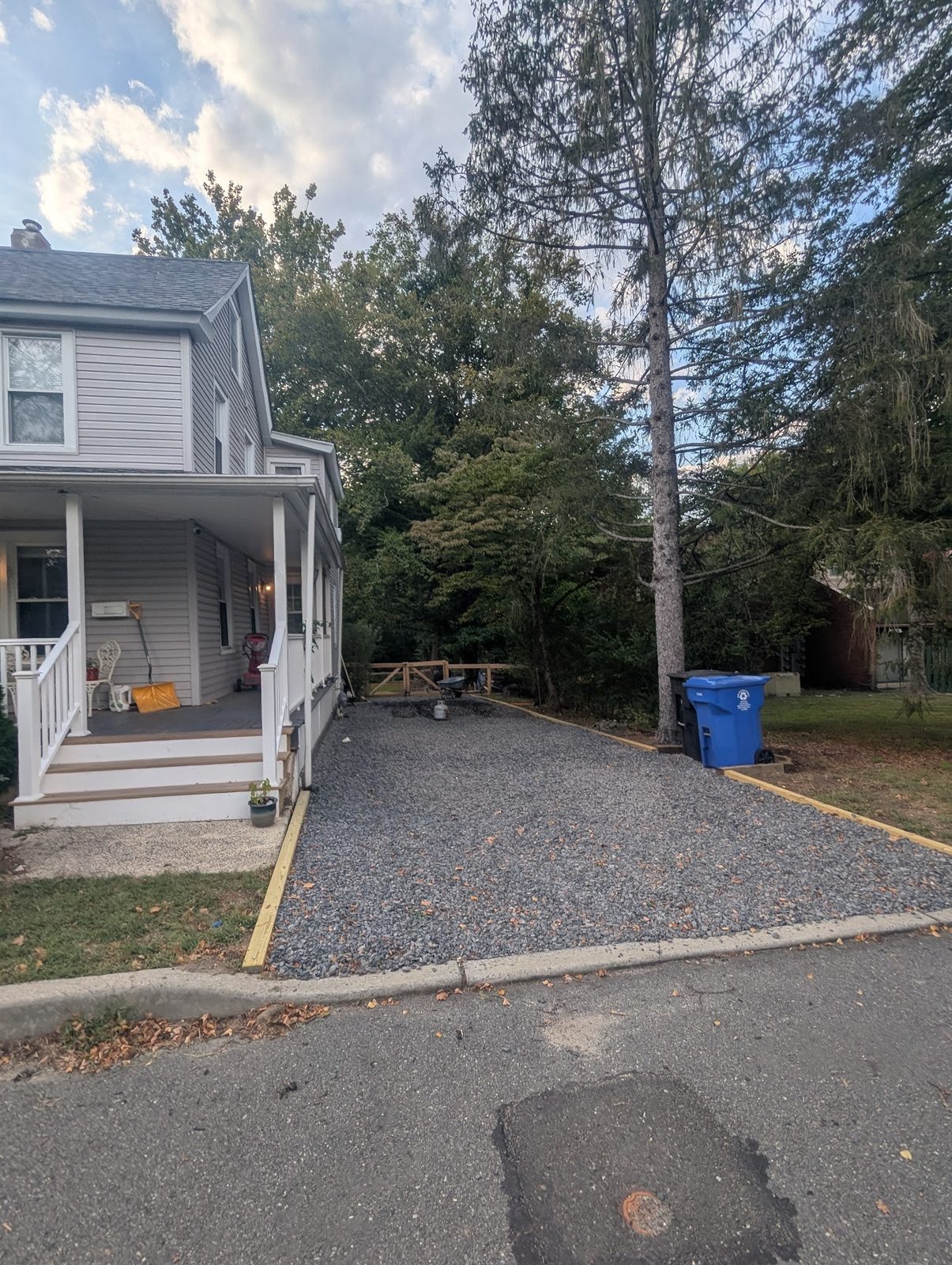 House and finished gravel driveway on a clear day