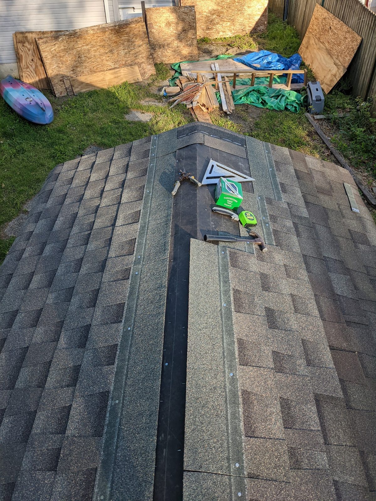 Overhead view of the finished shingled roof from a ladder