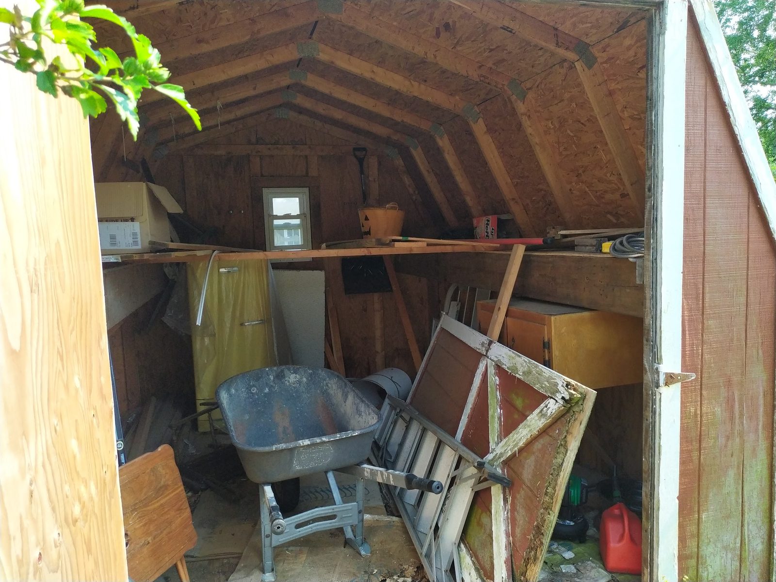Interior of the old shed with tools and boxes before I salvaged it for parts
